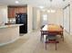 Dining area featuring a wooden dining table, perfect for meals and gatherings with an open concept kitchen at 7528 Park Hill Ave, Leesburg, FL 34748