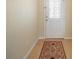 Entryway featuring tile floors and a decorative rug near the front door at 7528 Park Hill Ave, Leesburg, FL 34748