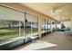 Relaxing screened-in porch featuring ceiling fans, outdoor seating, and views of the well-maintained yard at 7528 Park Hill Ave, Leesburg, FL 34748