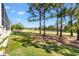 Beautiful backyard view with mature trees bordering the golf course offering privacy and serenity at 7885 Se 166Th Hibernia Ln, The Villages, FL 32162