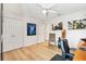 Bedroom with ceiling fan, a desk, and framed memorabilia at 7885 Se 166Th Hibernia Ln, The Villages, FL 32162