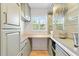 Charming butler's pantry with light-colored cabinetry, wood counters, glass shelving, and a sunlit window at 7885 Se 166Th Hibernia Ln, The Villages, FL 32162