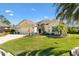 Well-maintained single-story home with lush landscaping, attached garage, and inviting curb appeal at 7885 Se 166Th Hibernia Ln, The Villages, FL 32162