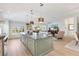 Open kitchen layout with a center island, pendant lights, and clear sightlines to the living area at 7885 Se 166Th Hibernia Ln, The Villages, FL 32162