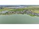 An aerial view of a waterfront community with green grass and a lake at 909 Egrets Landing Way, Groveland, FL 34736