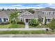 Aerial view of a single-Gathering home with lush lawn, landscaped yard, and a striking red door at 909 Egrets Landing Way, Groveland, FL 34736