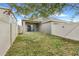 A fenced backyard featuring green grass and a covered patio at 909 Egrets Landing Way, Groveland, FL 34736