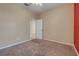 Bedroom with carpet flooring and a door that leads into another room at 909 Egrets Landing Way, Groveland, FL 34736