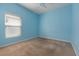 Bedroom with carpet flooring, a ceiling fan, a window with blinds, and light blue walls at 909 Egrets Landing Way, Groveland, FL 34736