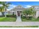 Charming one-story home featuring a well-manicured lawn, and tropical landscaping at 909 Egrets Landing Way, Groveland, FL 34736