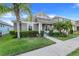 Charming single-Gathering home with manicured lawn, decorative shrubbery and a gray exterior at 909 Egrets Landing Way, Groveland, FL 34736