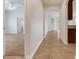 Hallway with tile flooring that leads to the bedroom and kitchen at 909 Egrets Landing Way, Groveland, FL 34736