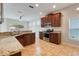 Modern kitchen featuring stainless steel appliances, granite countertops, and wood cabinets at 909 Egrets Landing Way, Groveland, FL 34736