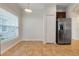 An open kitchen with stainless steel refrigerator and pendant light at 909 Egrets Landing Way, Groveland, FL 34736