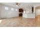 Open-concept living area leading into a kitchen with granite counters at 909 Egrets Landing Way, Groveland, FL 34736