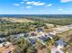 Wide aerial view of a rural neighborhood, showcasing home placement and surrounding landscape at 9513 Mid Summer Ln, Leesburg, FL 34788