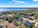 Stunning aerial view of the property featuring a private pool, manicured lawn and lake views at 9513 Mid Summer Ln, Leesburg, FL 34788