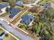 Aerial view of a fenced property showcasing a private pool and patio with green spaces at 9513 Mid Summer Ln, Leesburg, FL 34788