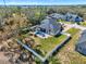 Aerial view of a home with in-ground pool, luscious lawn and a white fence at 9513 Mid Summer Ln, Leesburg, FL 34788