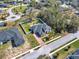 Beautiful aerial view of a home with a brick driveway and manicured lawn surrounded by a white fence at 9513 Mid Summer Ln, Leesburg, FL 34788