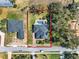 Aerial view of property featuring the backyard pool, fence, and red brick driveway at 9513 Mid Summer Ln, Leesburg, FL 34788