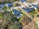 Aerial view of home featuring a private backyard pool, patio, and a lush green lawn at 9513 Mid Summer Ln, Leesburg, FL 34788