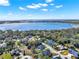 Expansive aerial view showcases the lake, neighborhood and lush greenery surrounding the homes at 9513 Mid Summer Ln, Leesburg, FL 34788