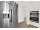 Stainless steel refrigerator and oven with white cabinetry, and wood-style tile flooring at 9513 Mid Summer Ln, Leesburg, FL 34788