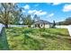 Expansive backyard with white fence, lush grass and landscaping at 9513 Mid Summer Ln, Leesburg, FL 34788