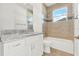 Bathroom featuring a vanity with granite countertops and tiled shower at 9513 Mid Summer Ln, Leesburg, FL 34788