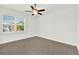 Bright bedroom with neutral carpet, ceiling fan, and one window at 9513 Mid Summer Ln, Leesburg, FL 34788