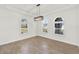 Bright dining room featuring large arched windows, tile floors, and a modern chandelier at 9513 Mid Summer Ln, Leesburg, FL 34788