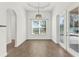 Dining area with modern light fixture and sliding doors to the outdoor area at 9513 Mid Summer Ln, Leesburg, FL 34788