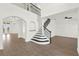 Elegant foyer featuring wood-look tile flooring and an elegant staircase at 9513 Mid Summer Ln, Leesburg, FL 34788