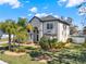 Beautiful two-story home with a well-manicured lawn and tropical palm trees at 9513 Mid Summer Ln, Leesburg, FL 34788