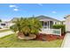 Beautiful home with a lush tropical landscaping, screened porch, and a well-manicured lawn at 993 Davit Pl, The Villages, FL 32162