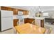 Bright kitchen with white countertops, wooden cabinets, and an adjacent dining area at 993 Davit Pl, The Villages, FL 32162