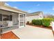 Enjoy outdoor living on this home's screened-in patio with a view of the landscaped backyard at 993 Davit Pl, The Villages, FL 32162