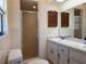 Well-lit bathroom featuring dual sinks, a walk-in shower, and tiled walls at 1009 Linda Glen Ave, Fruitland Park, FL 34731