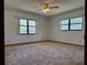 Bright bedroom with large windows, neutral carpet, and ample natural light at 1009 Linda Glen Ave, Fruitland Park, FL 34731
