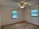 Bedroom featuring neutral walls, carpet, a ceiling fan, and windows offering plenty of natural light at 1009 Linda Glen Ave, Fruitland Park, FL 34731