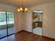 Dining area featuring hardwood floors, a hanging chandelier, and a view of the kitchen at 1009 Linda Glen Ave, Fruitland Park, FL 34731