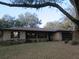 Charming single-story brick home featuring a well-manicured front lawn and attached garage at 1009 Linda Glen Ave, Fruitland Park, FL 34731