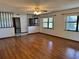 Open living room featuring hardwood floors, natural light, and a view of the front yard at 1009 Linda Glen Ave, Fruitland Park, FL 34731