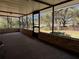 Screened in patio with brick support columns offering views of the large wooded property at 1009 Linda Glen Ave, Fruitland Park, FL 34731