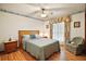 Cozy bedroom with ceiling fan, wood-look floors, and natural light, creating a warm atmosphere at 10122 Canterbury Dr, Leesburg, FL 34788