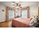 Inviting bedroom with wood-look floors and plenty of sunlight, offering a comfortable retreat at 10122 Canterbury Dr, Leesburg, FL 34788