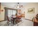 View of a formal dining room with natural light and tile floors at 10122 Canterbury Dr, Leesburg, FL 34788