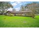 Charming single-story home with a well-maintained lawn and mature landscaping at 10122 Canterbury Dr, Leesburg, FL 34788