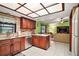 Open kitchen with granite counters, stainless steel appliances, and tile flooring at 10122 Canterbury Dr, Leesburg, FL 34788